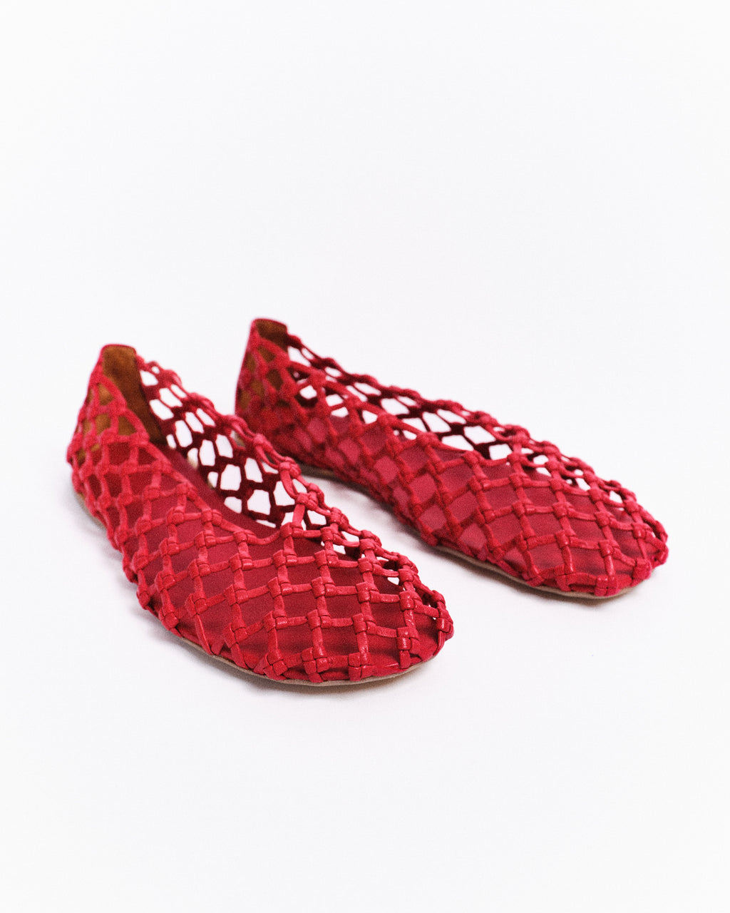 Red woven shoes on a white background
