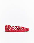 Red woven flat shoe on a white background