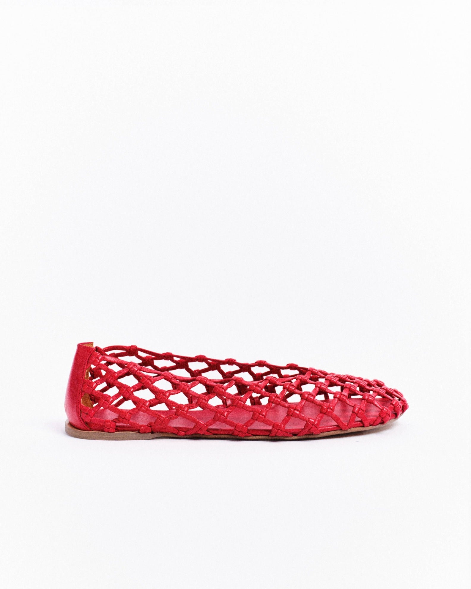 Red woven flat shoe on a white background