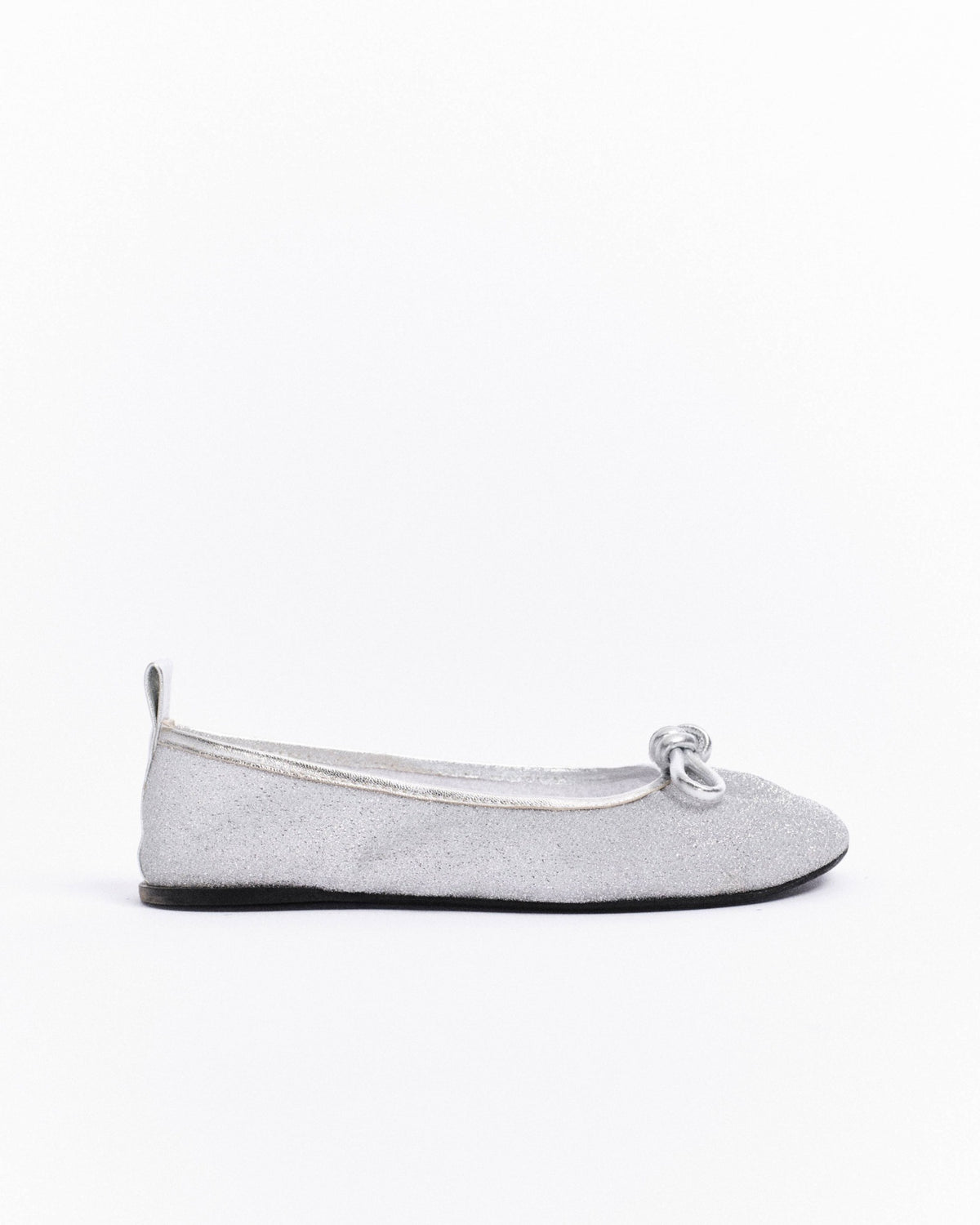 Silver glittery barefoot flat shoe on a white background